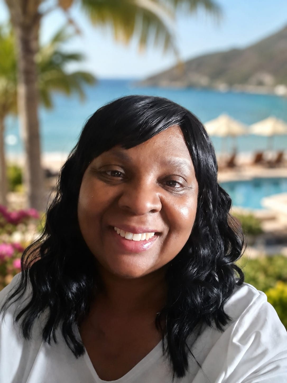 Jennive Bobb, personal travel agent, smiling at a tropical resort